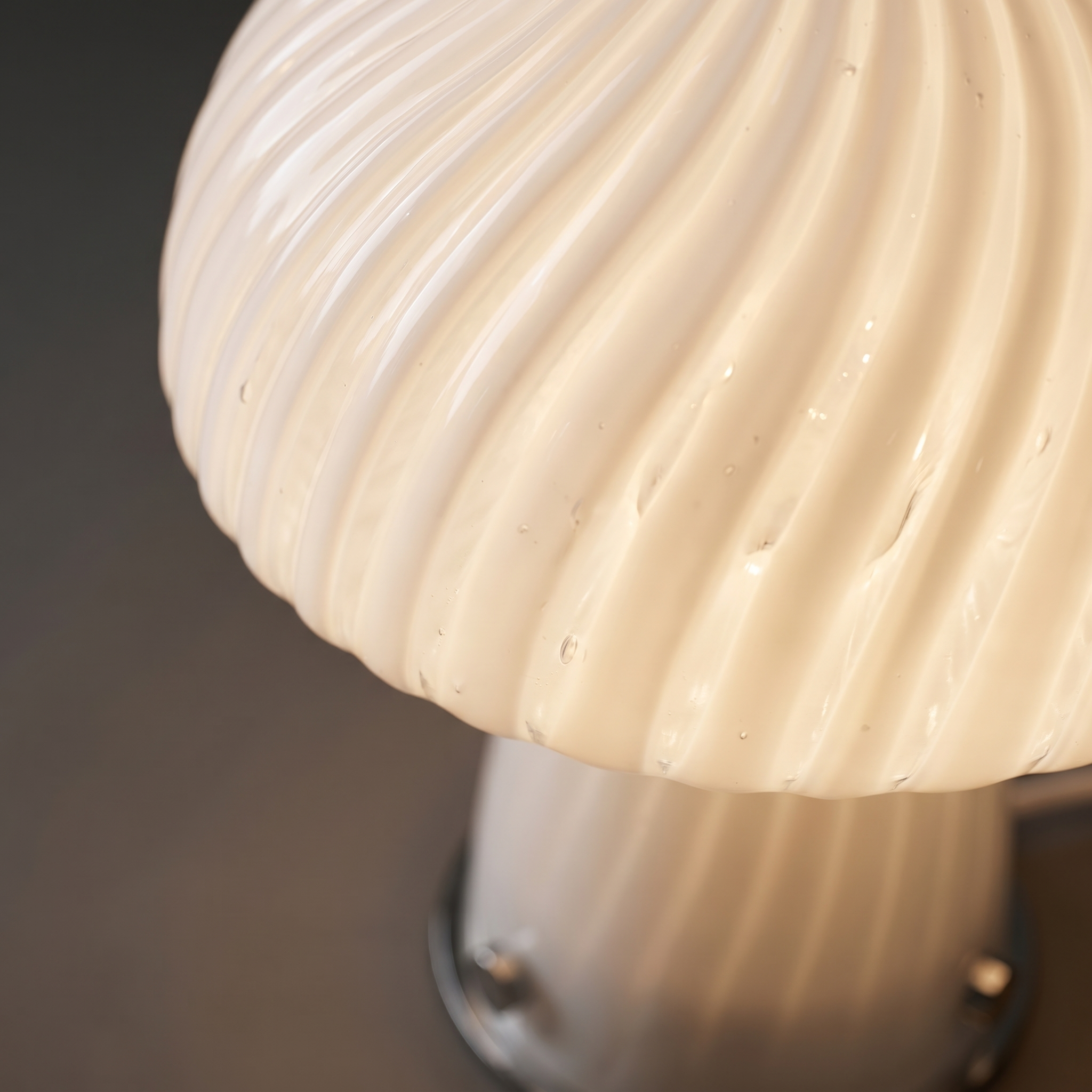 Close-up detail of the premium swirl glass texture and warm glow